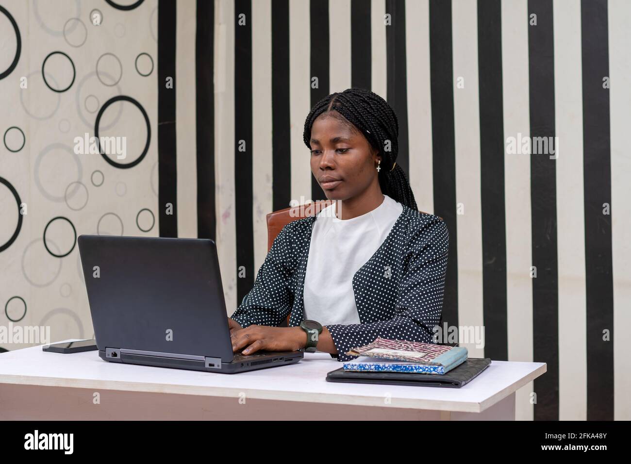 Young beautiful African businesswoman working on her laptop Stock Photo ...