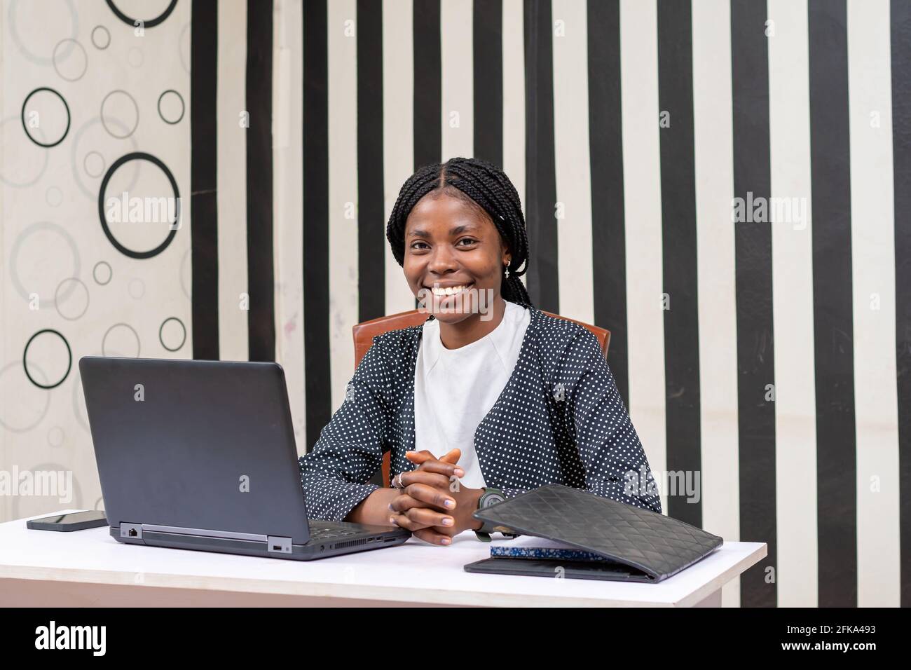 Beautiful African businesswoman smiling in the office Stock Photo - Alamy