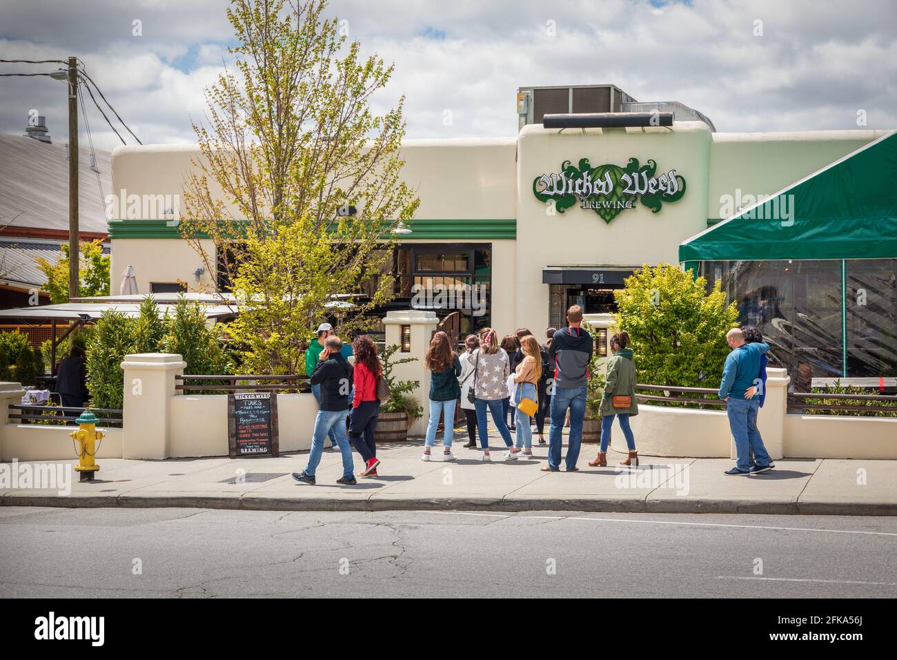 ASHEVILLE, NC, USA-25 APRIL 2021: The Wicked Weed Brewing Co. on Biltmore Ave. has a waiting line for lunch. Stock Photo