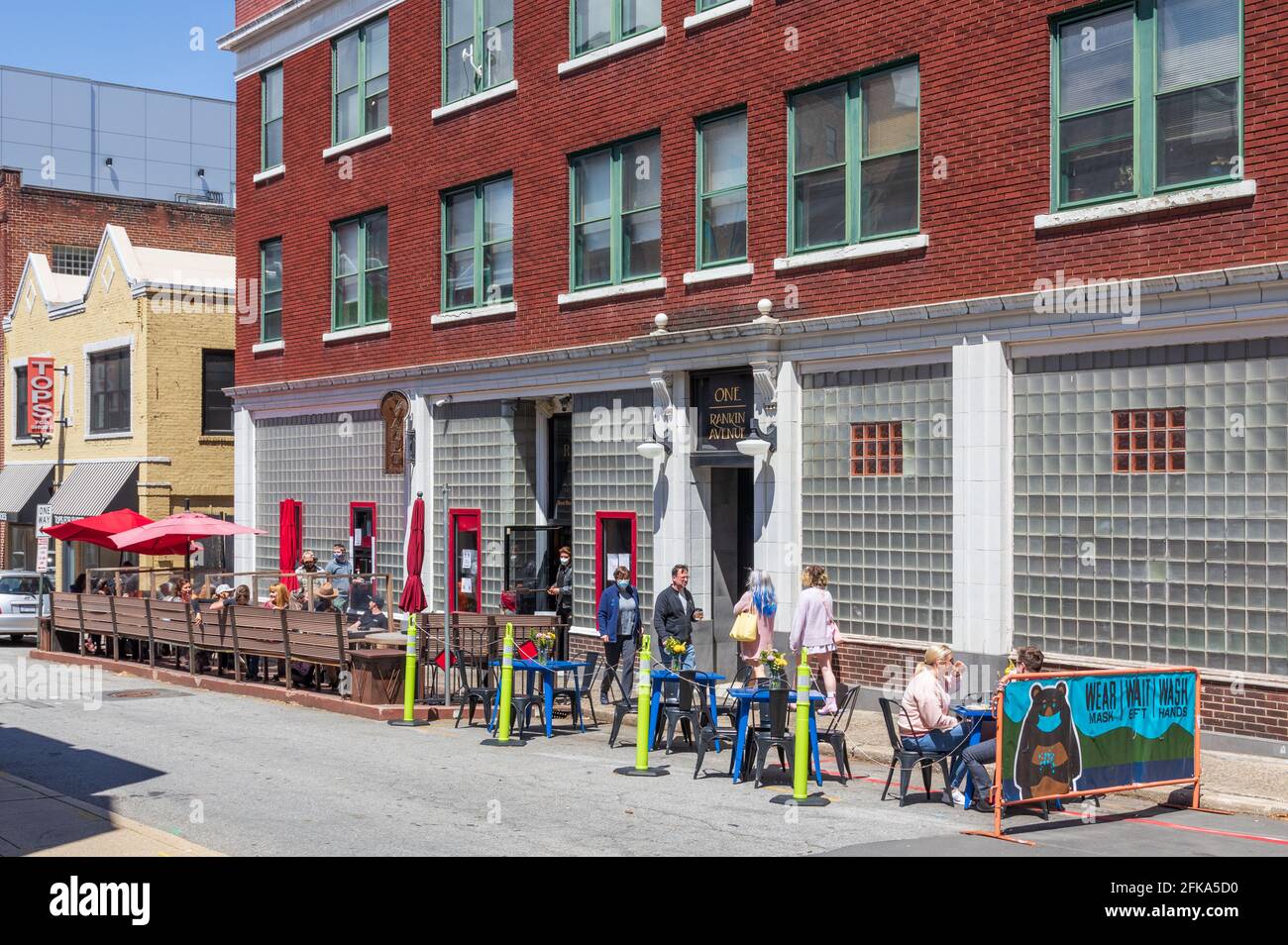 ASHEVILLE, NC, USA-25 APRIL 2021: Rankin Vault Cocktail Lounge, at One Rankin Avenue, with busy sidewalk seating on a sunny, spring day.  People. Stock Photo