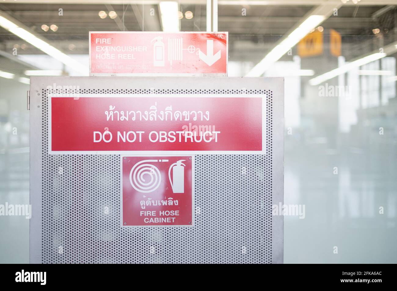 Red fire alarm sign on the white wall for safety first and sign for