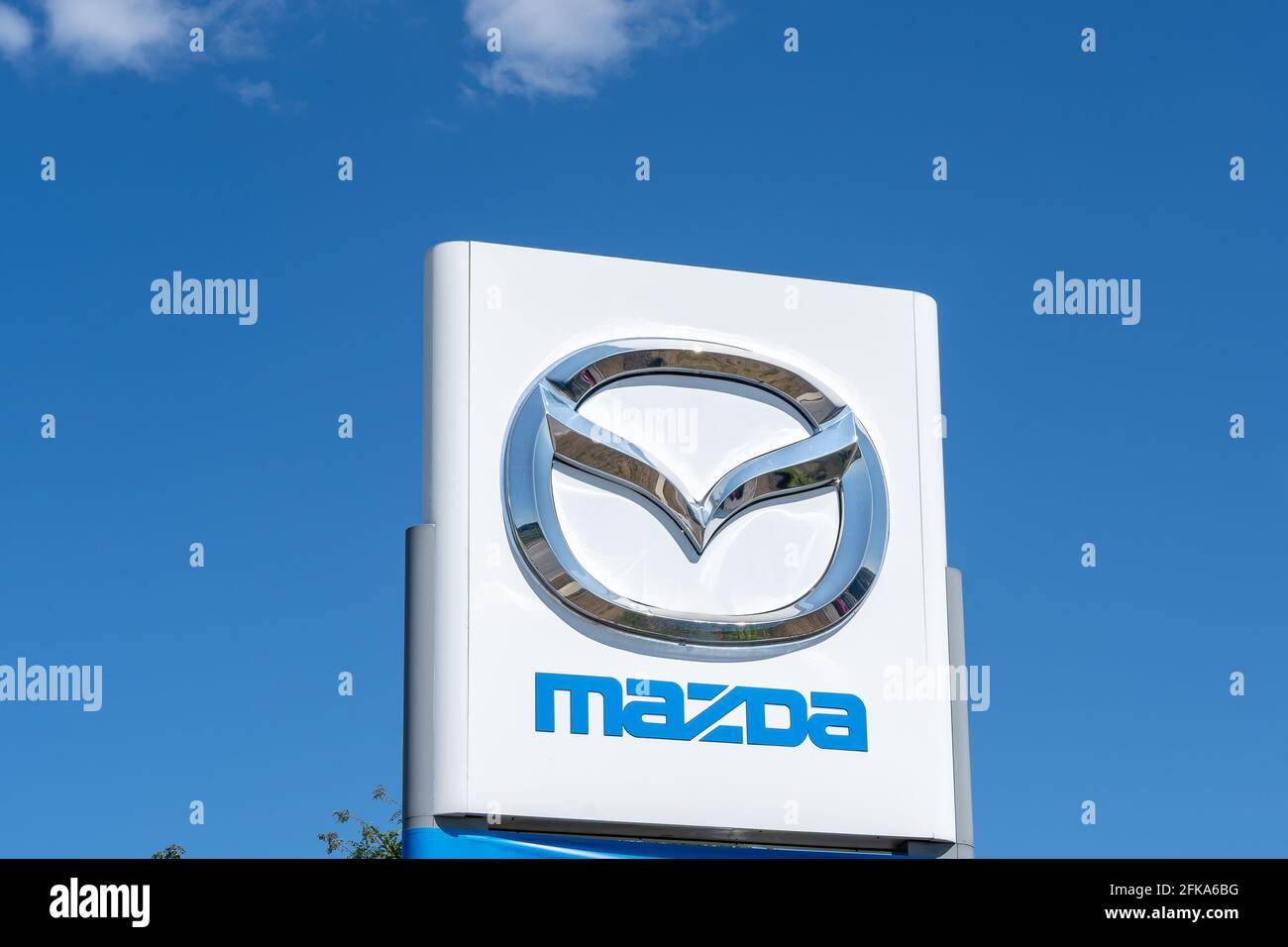 Barrie, Ontario, Canada - August 4, 2019: Close up of Mazda sign with blue sky in background. Stock Photo