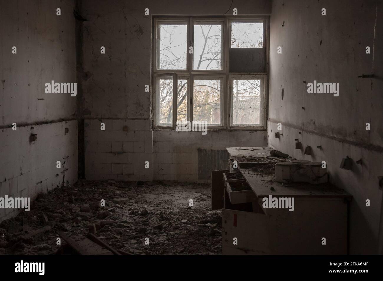 Picture of a damaged interior of an abandoned office building with a