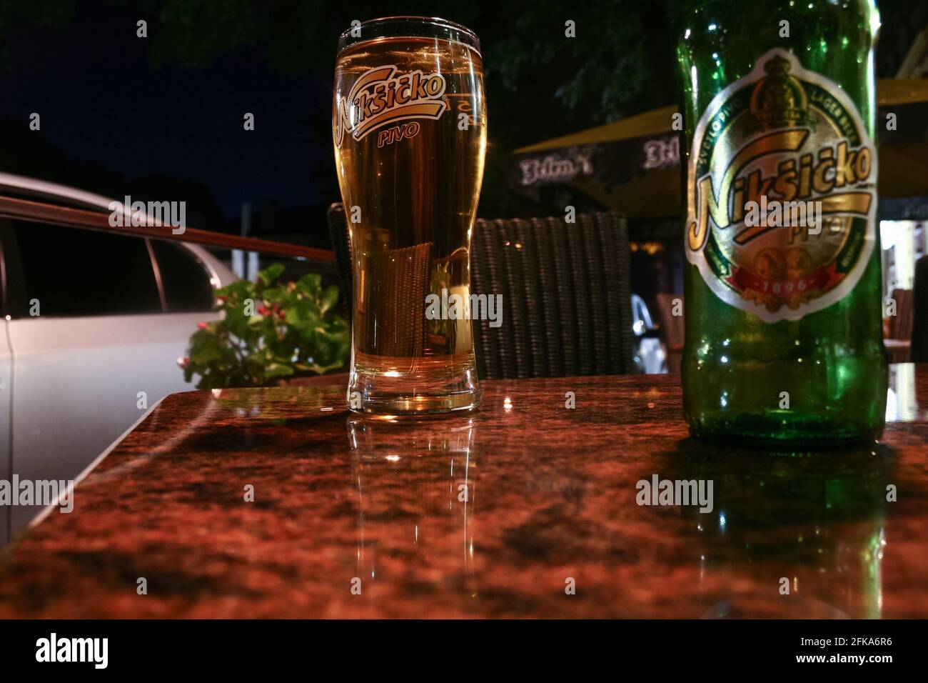 Picture of a glass with the logo of Niksicko beer on a bar selling it in Niksic. Trebjesa Brewery is the largest brewery in Montenegro. It is based in Stock Photo