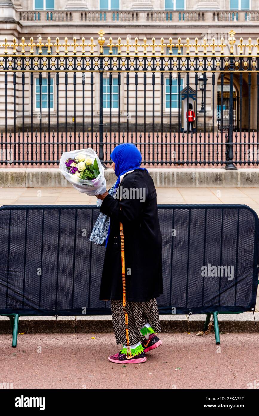 A Muslim Woman Pays Her Respects To Prince Philip (The Duke Of Edinburgh) By Laying Flowers At