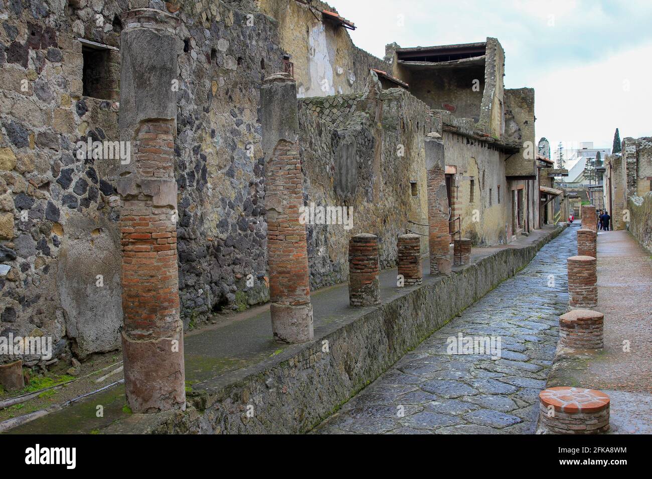 Ancient street with columns and buildings in Pompeii, Italy Stock Photo