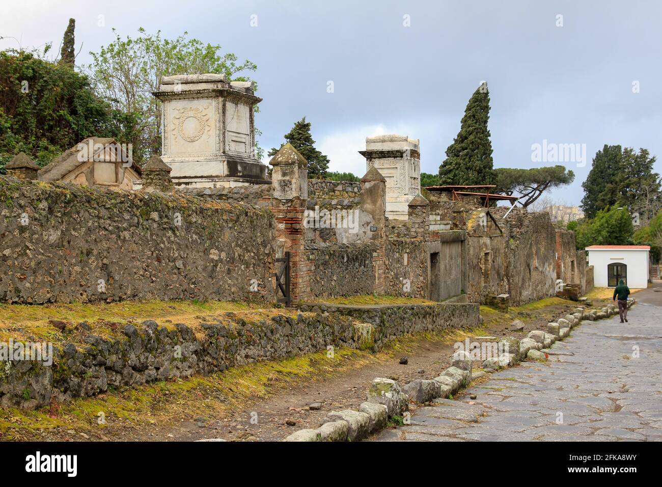 Necropolis with tombs behind stone wall in Pompeii, Italy Stock Photo