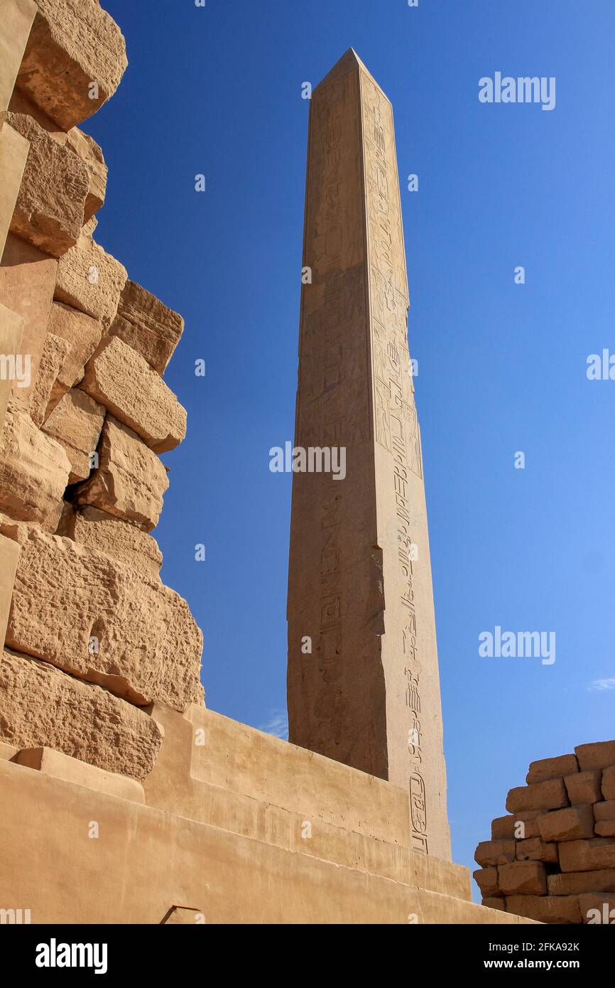 Obelisk of Thutmosis I with blue sky and ruins in Temples of Karnak, Luxor, Egypt Stock Photo