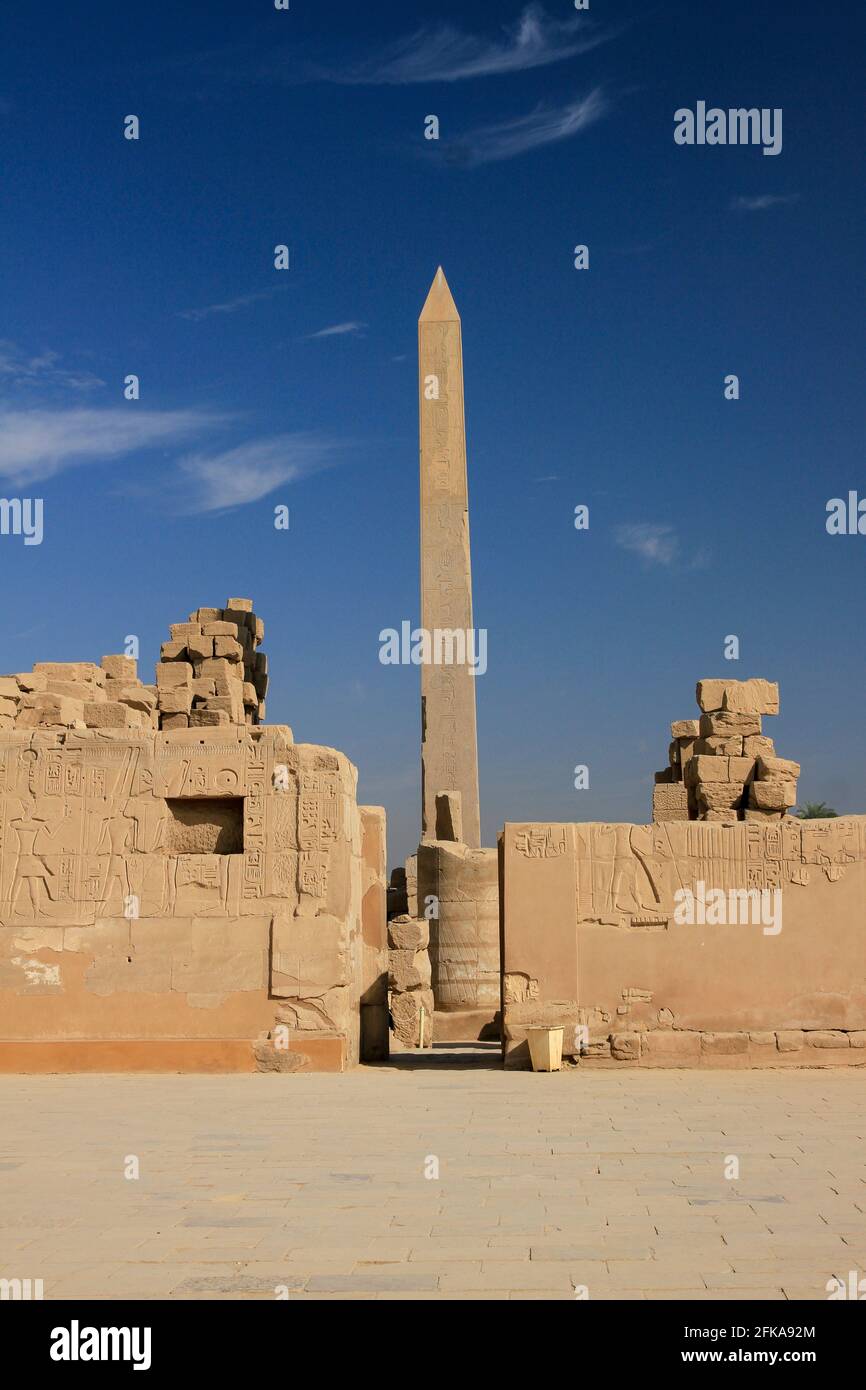 Obelisk of Thutmosis I with blue sky and ruins in Temples of Karnak, Luxor, Egypt Stock Photo