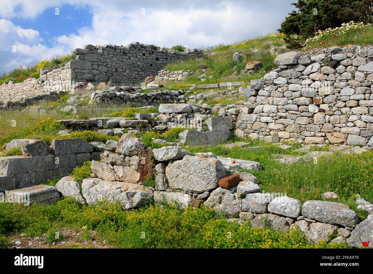 Stone ruins of Ancient Thera on Messavouno mountain with blue sky, Santorini, Greece Stock Photo