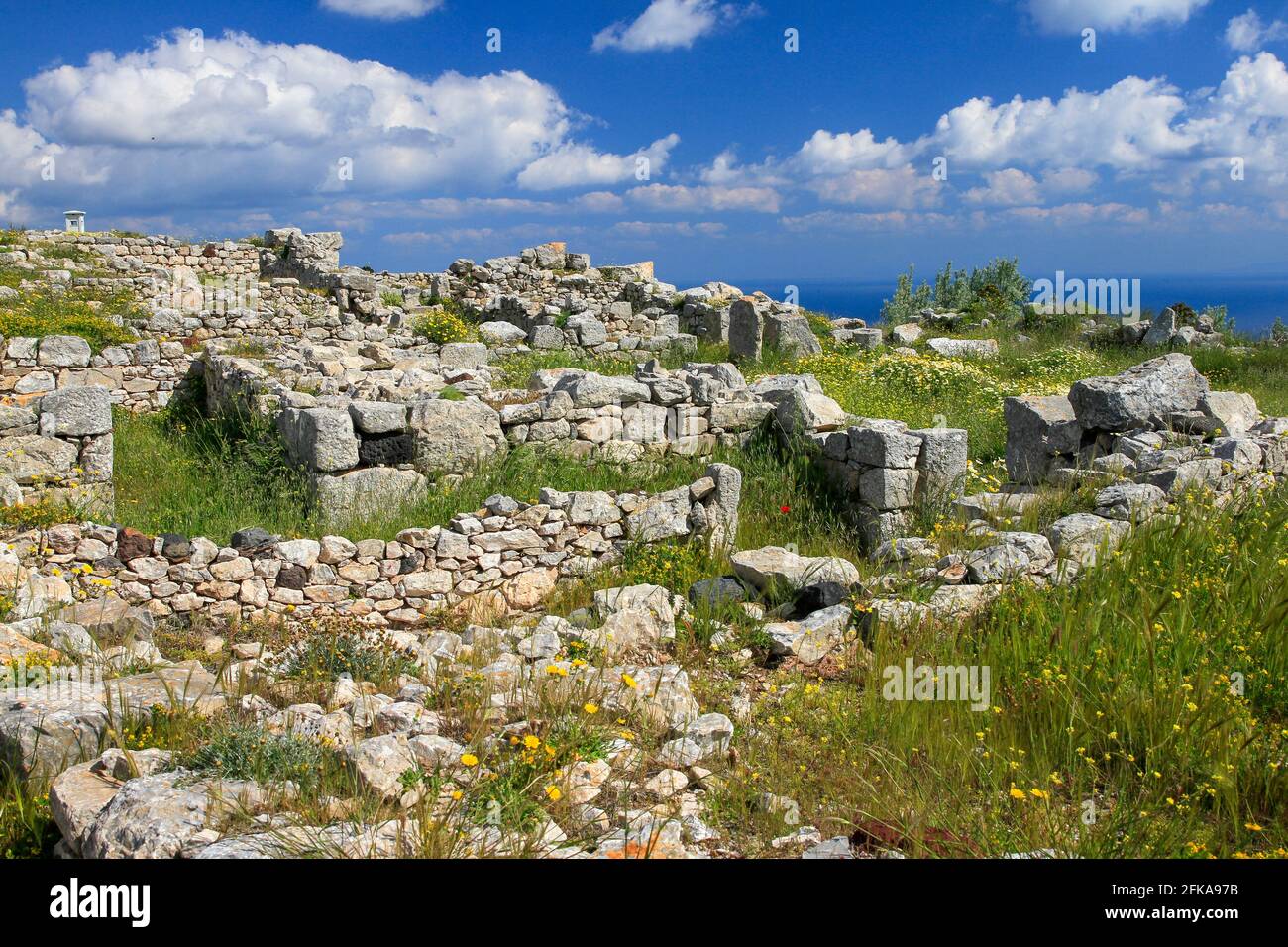 Stone ruins of Ancient Thera on Messavouno mountain with blue sky, Santorini, Greece Stock Photo