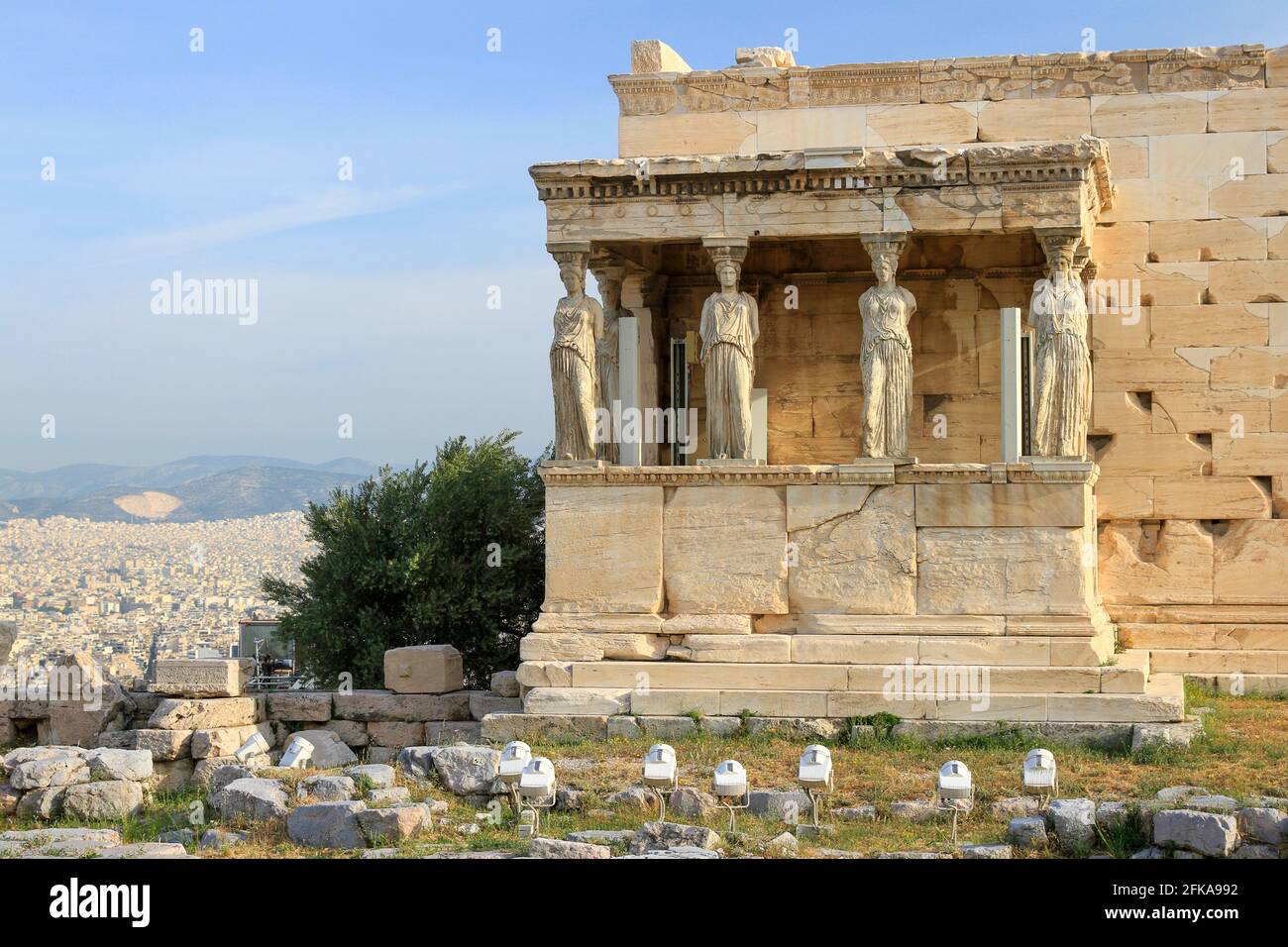 Porch of the Caryatids at the Erechtheion with city of Athens, Greece in background Stock Photo