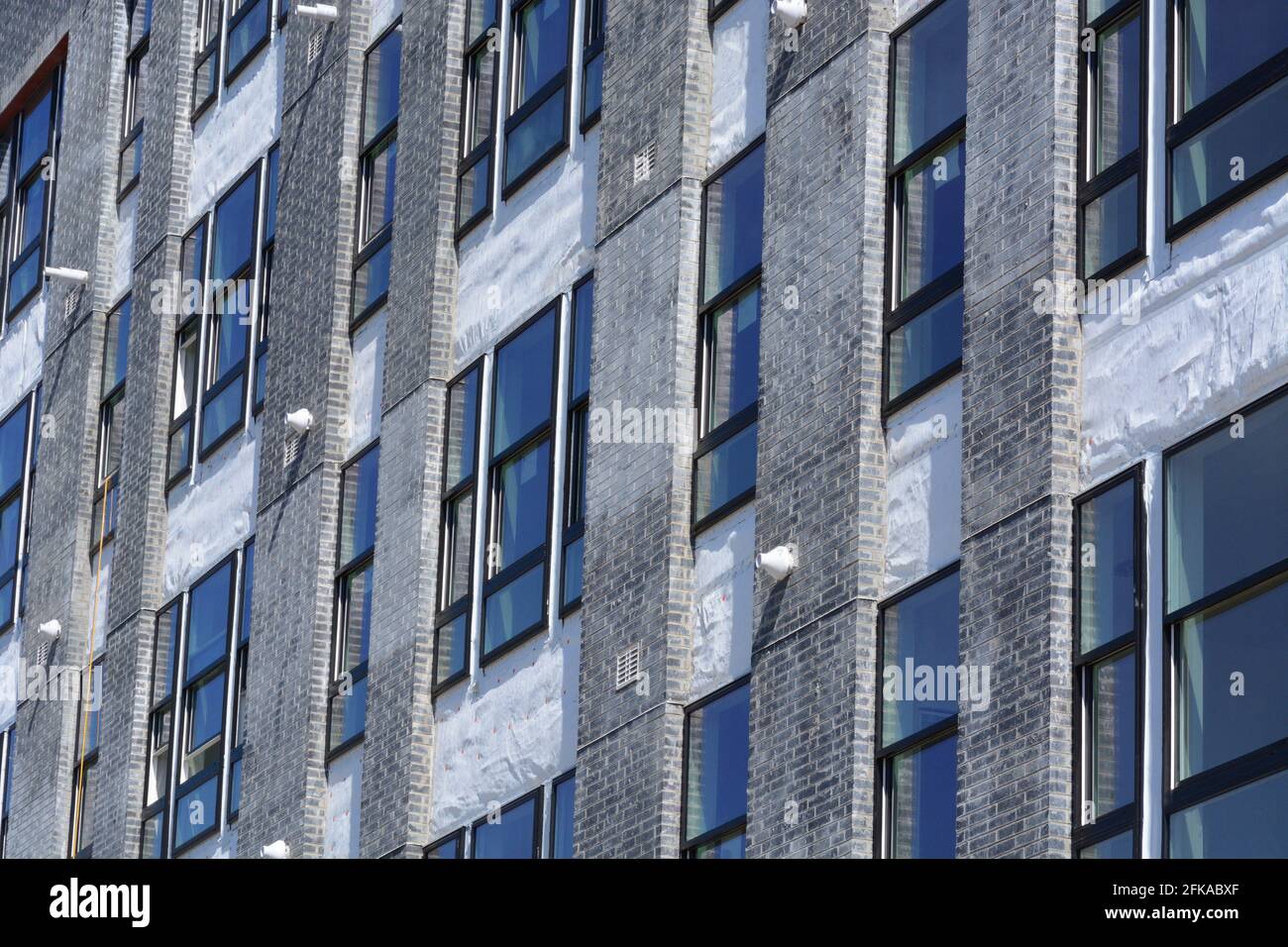 Construction of new building with windows and flashing tape still on exterior Stock Photo