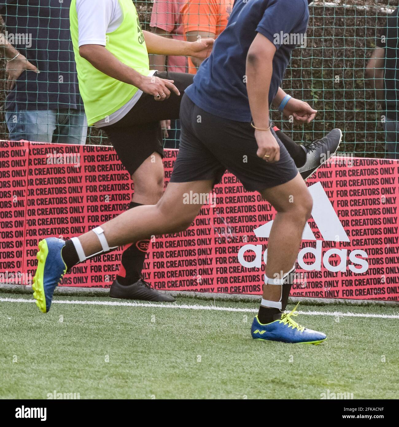 New Delhi, India - July 01 2018: Footballers of local football team during game in regional Derby championship on a bad football pitch. Hot moment of Stock Photo