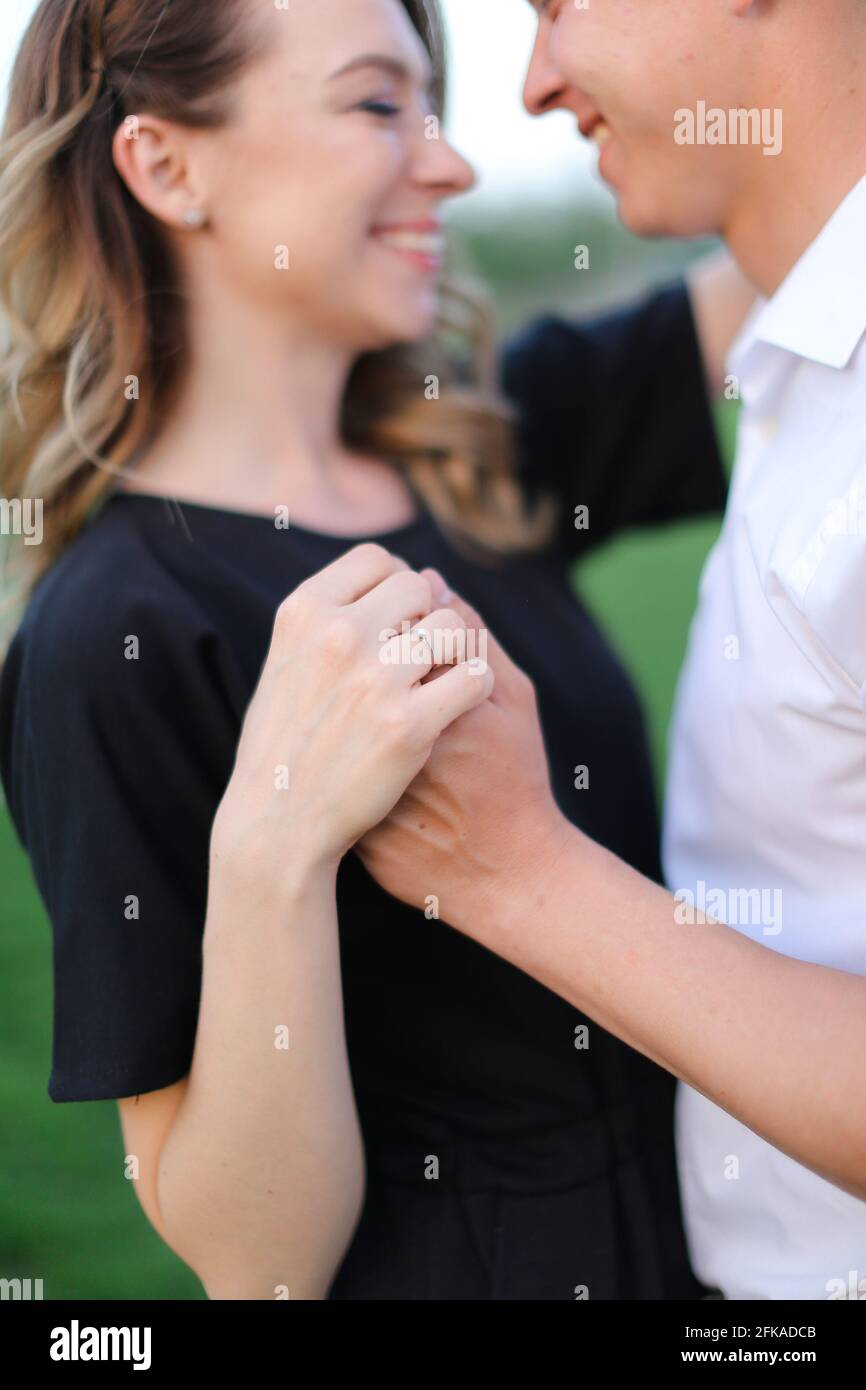 Focus On Ring And Arms Happy Boy And Girl Holding Hands Stock Photo focus-on-ring-and-arms-happy-boy-and-girl-holding-hands-stock-photo