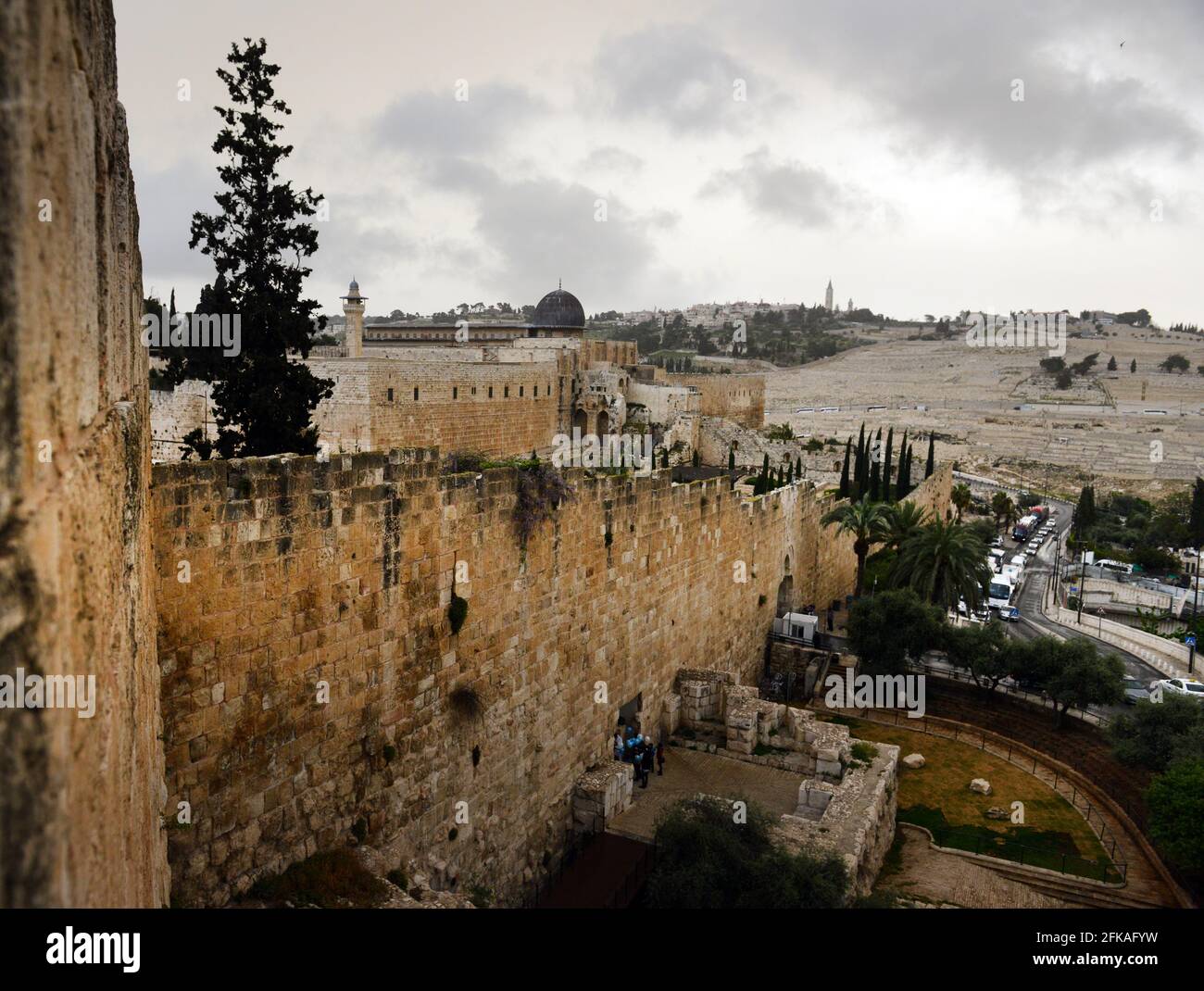 A view of the old city wall with the Temple Mount and the Mount of olives in the background. Stock Photo
