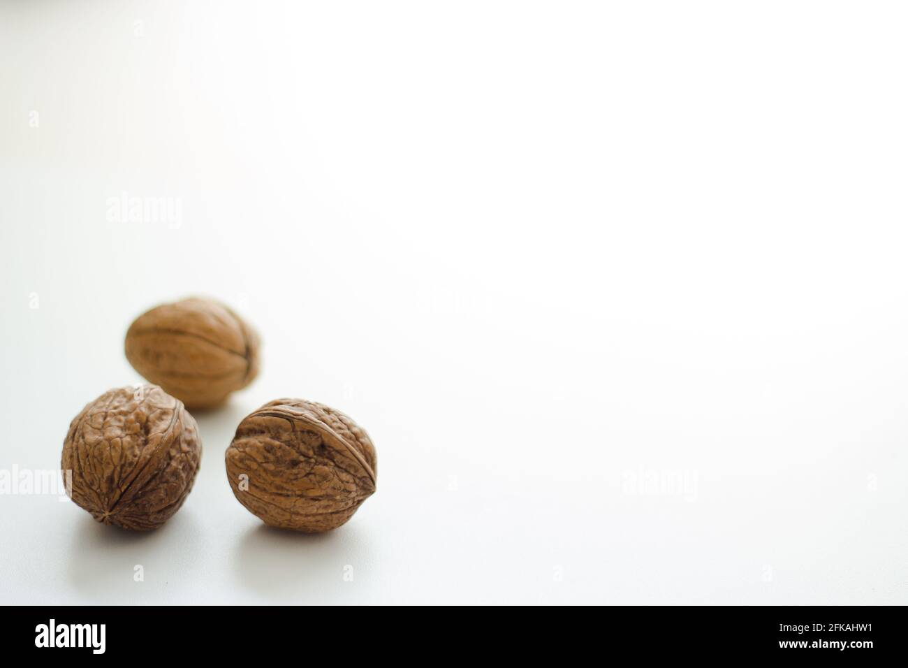 Three whole walnuts isolated on white background; autumn nuts Stock Photo