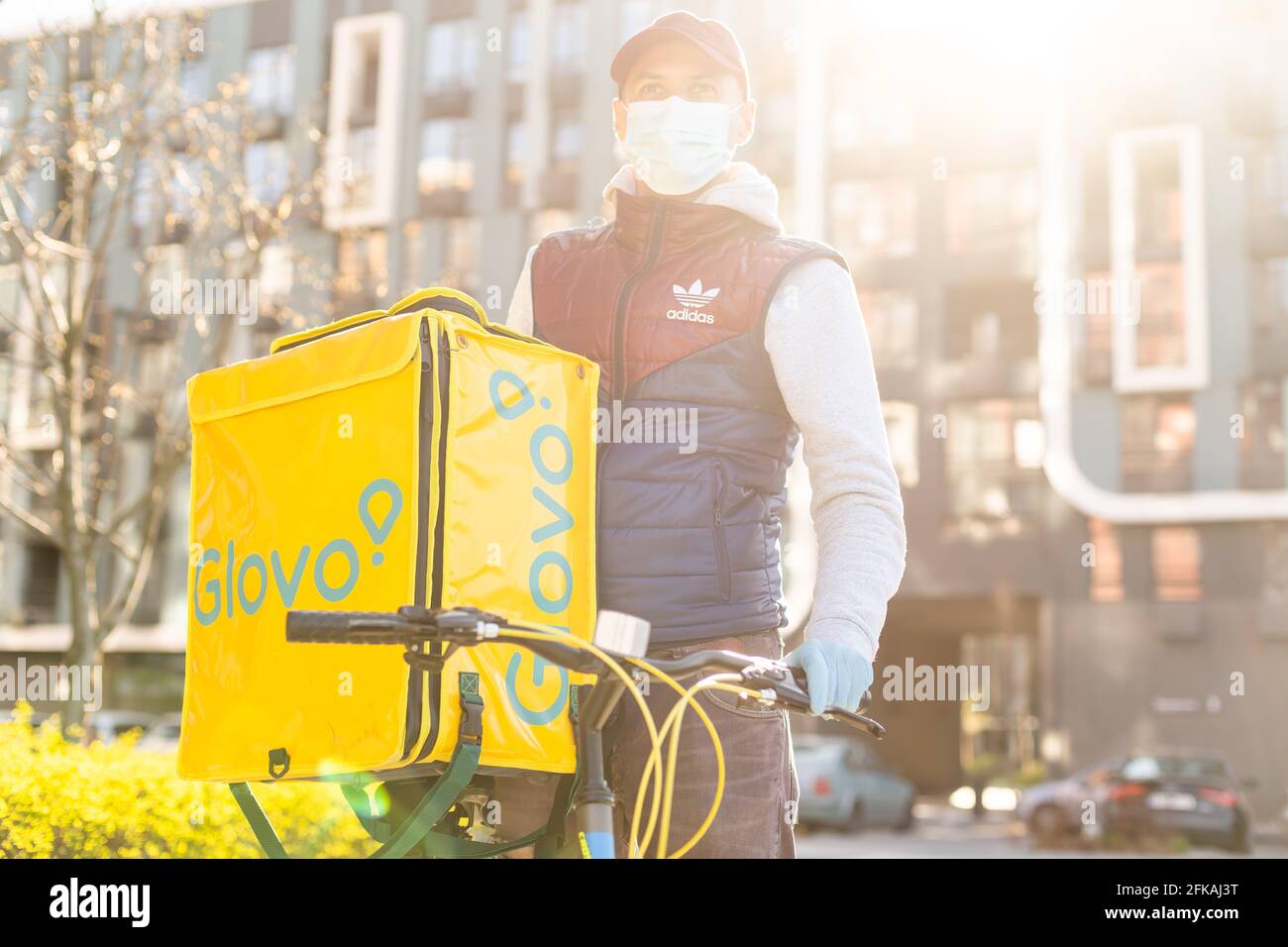 KIEV, UKRAINE - 28 April, 2021: Glovo delivery boy with famous yellow box  and bicycle on the street. delivery service worker on bike Stock Photo -  Alamy