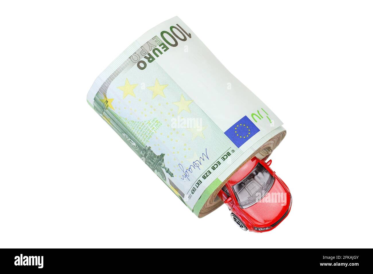 A red metal car inside a roll of banknote money isolated on white Stock Photo