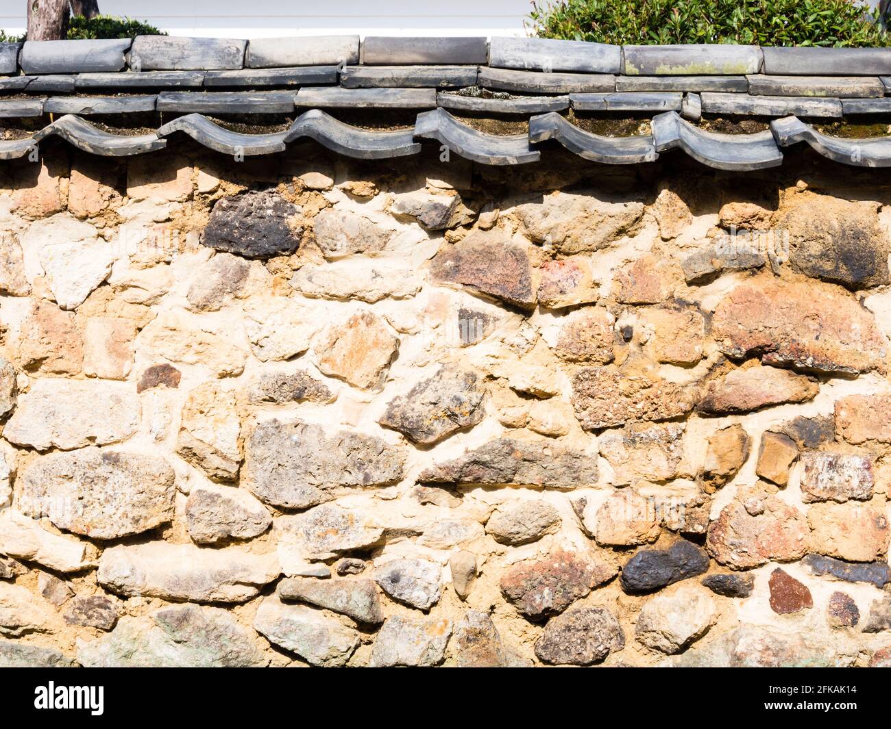 Old brick wall made with fragments of discarded pottry in the town of