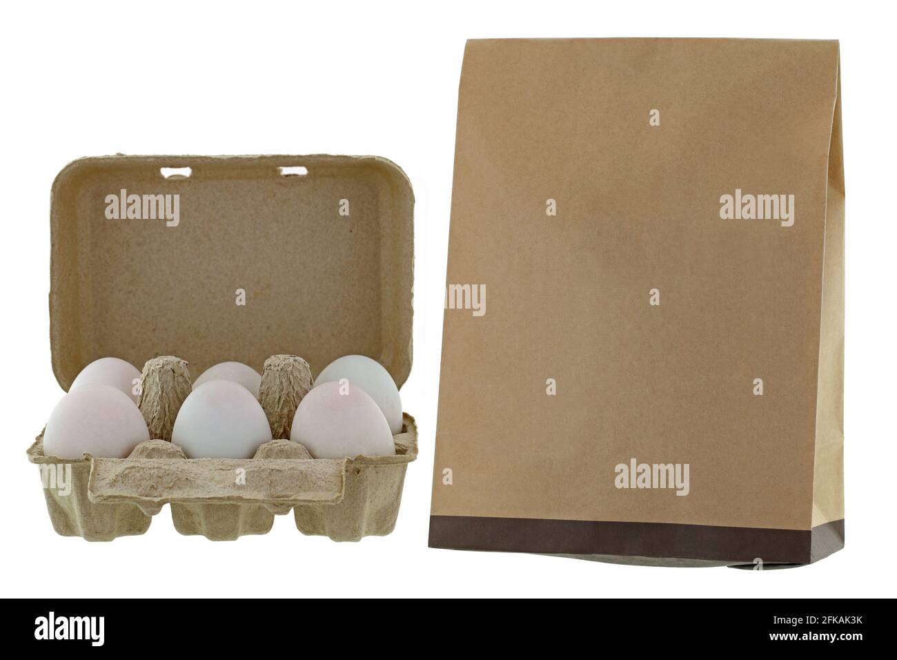 Paper pulp egg tray packages of fresh eggs next to brown recycled paper