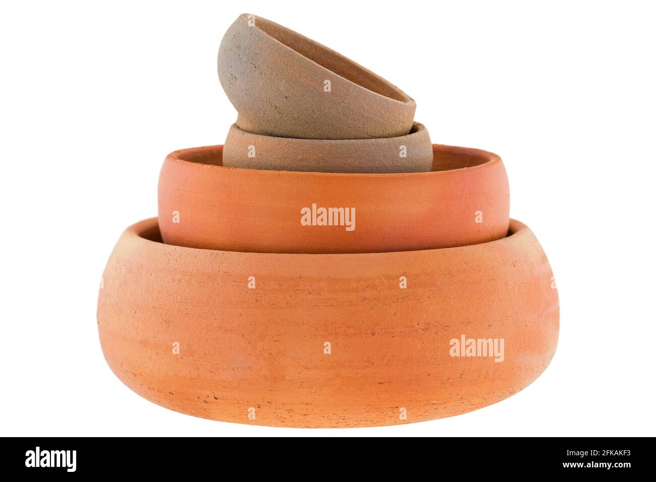 Stack of handmade round unglazed clay pots in different size isolated