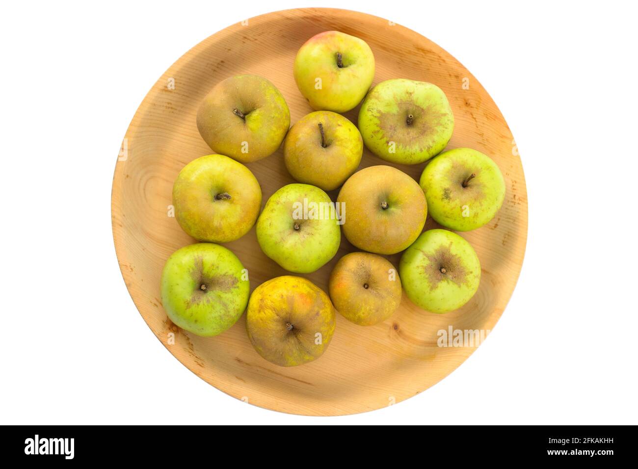Wooden bowl full of imperfect looking organic apples with unconventionally raised method, no genetically modified organism techniques Stock Photo