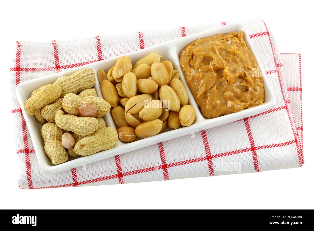 A dish of roasted groundnuts, salted peanuts and peanut butter, isolated on white Stock Photo