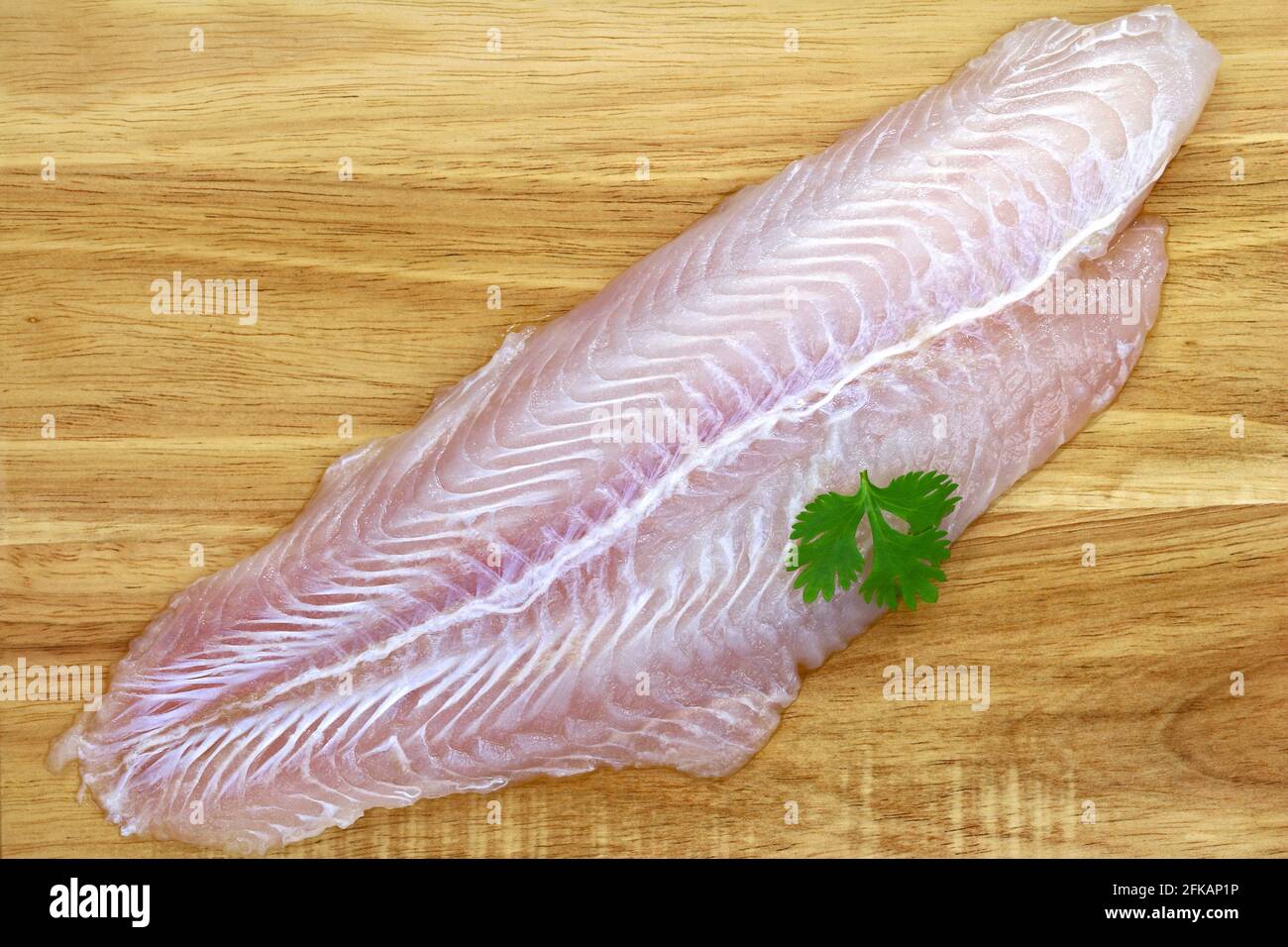 Fillet of Fresh water fish, Pangasius on a wooden background Stock Photo