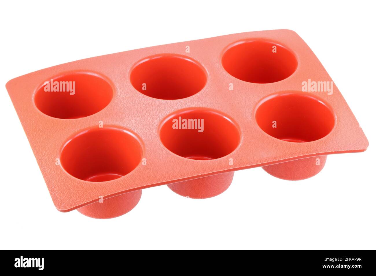 Red silicone mold to make muffin and cupcake, isolated on white Stock Photo