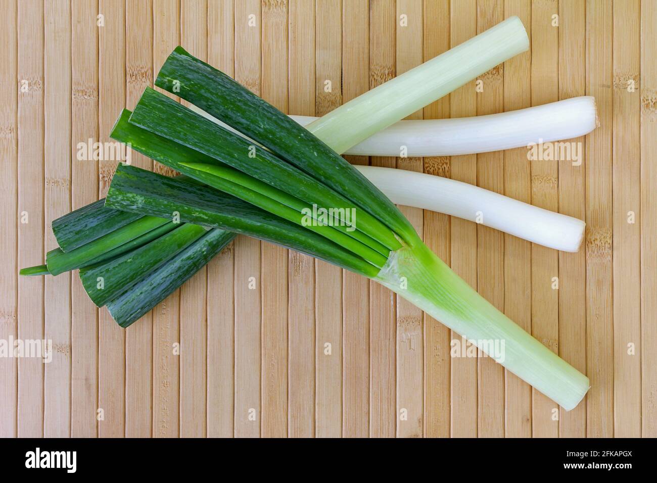 Huge stalks of fresh Japanese Leeks (Negi) on a wooden background Stock