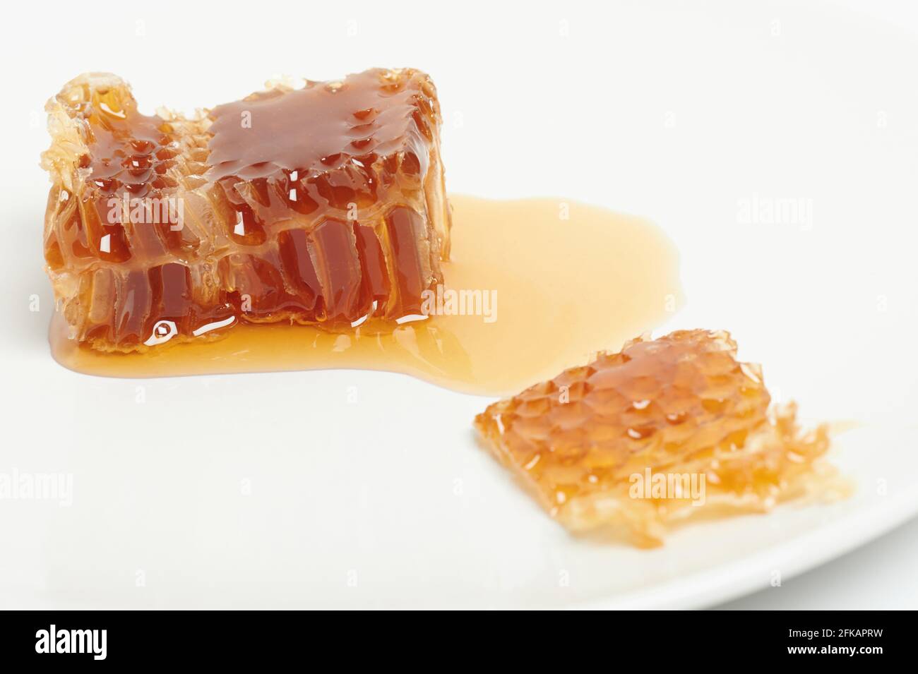 Tasty yellow honeycomb with liquid macro close up view Stock Photo