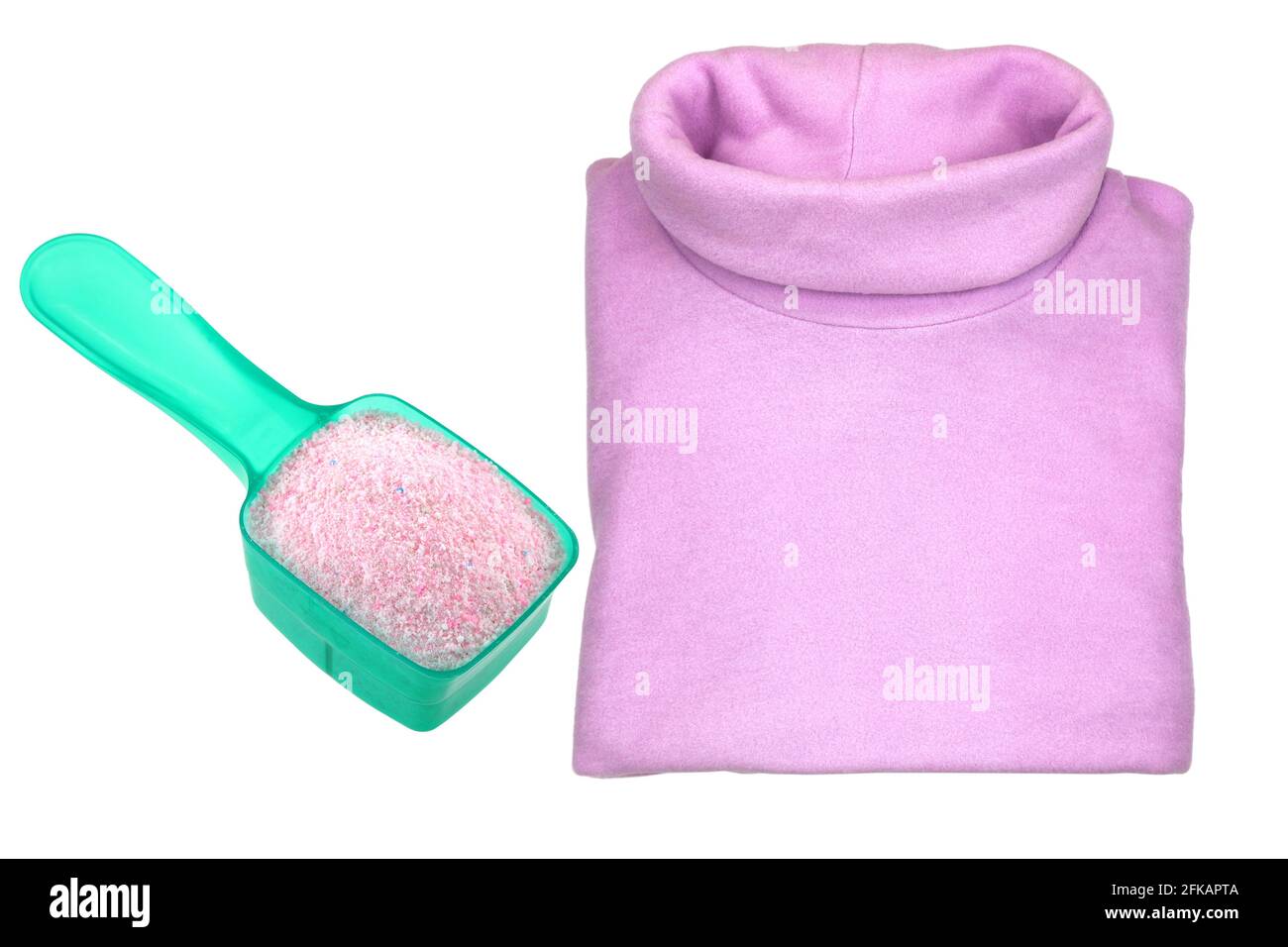 A pink heat retaining extra warm folded turtleneck t shirt with a spoon of washing Powder,  isolated on white background Stock Photo