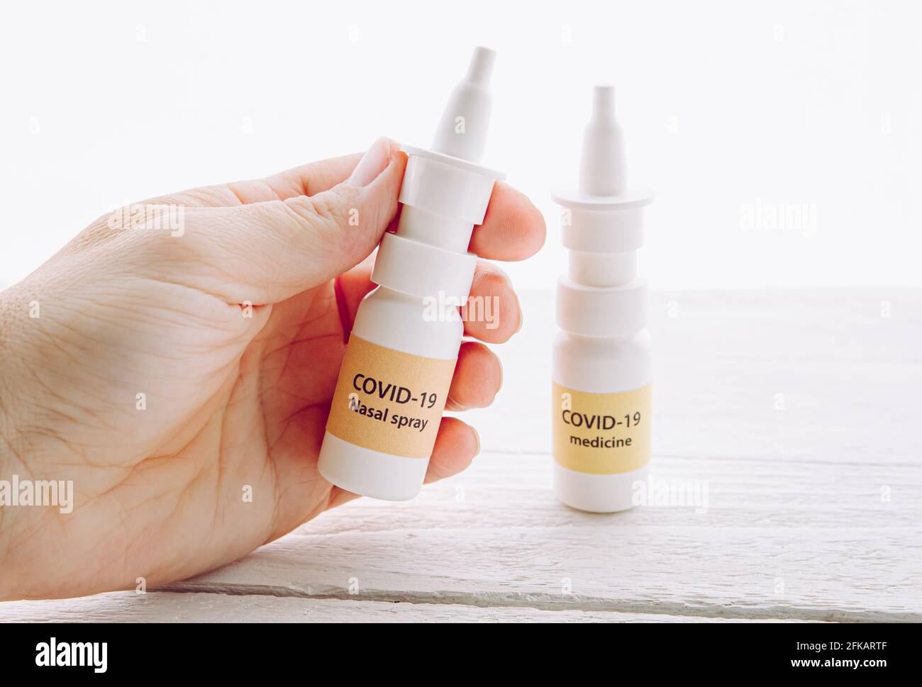 Person holding new treatment against Coronavirus COVID-19 nasal spray. Conceptual image of person hand holding new innovative nasal spray bottle. Stock Photo