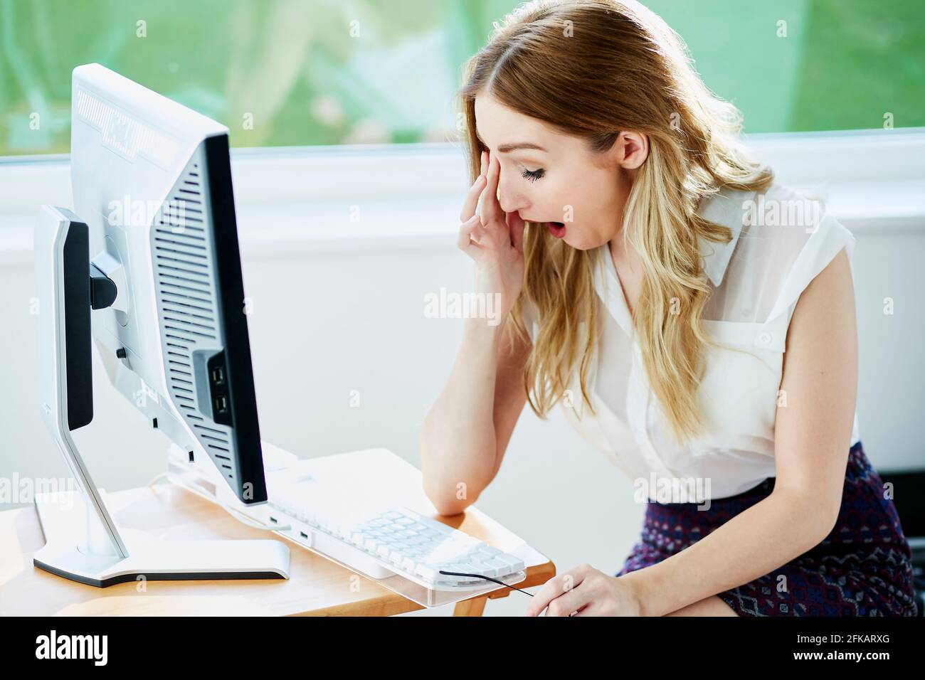 Tired woman at work Stock Photo