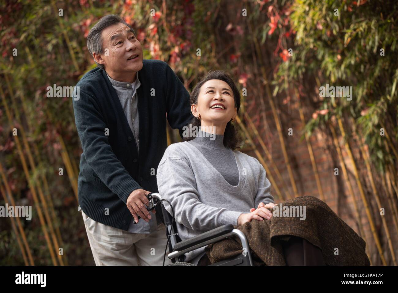 The old man pushed the wheelchair's wife Stock Photo