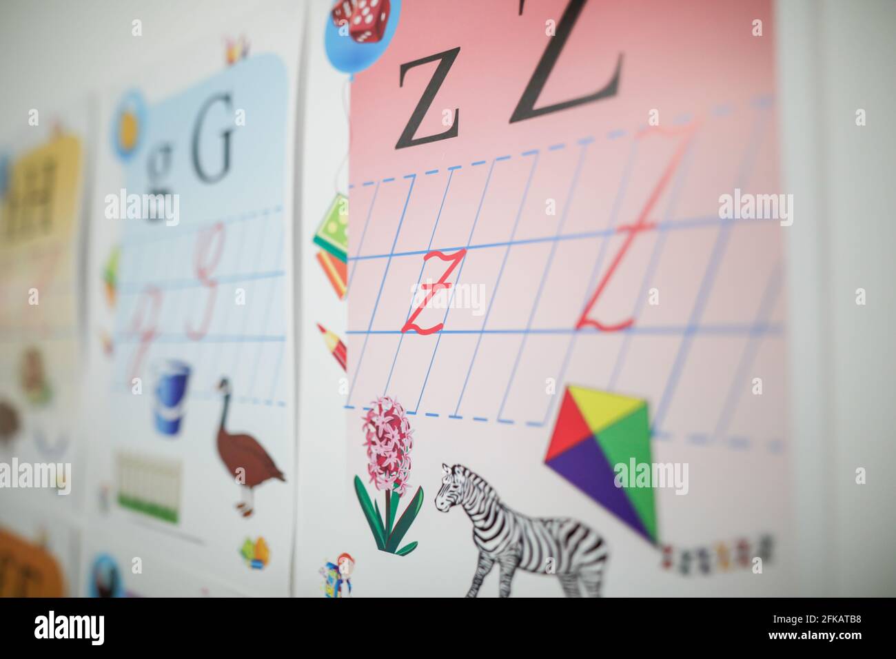 Shallow depth of field (selective focus) image with letters, animals and symbols on the wall of an elementary school Stock Photo