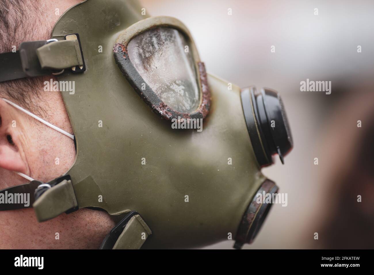 Masked man, double exposure with mask in hand and facial features