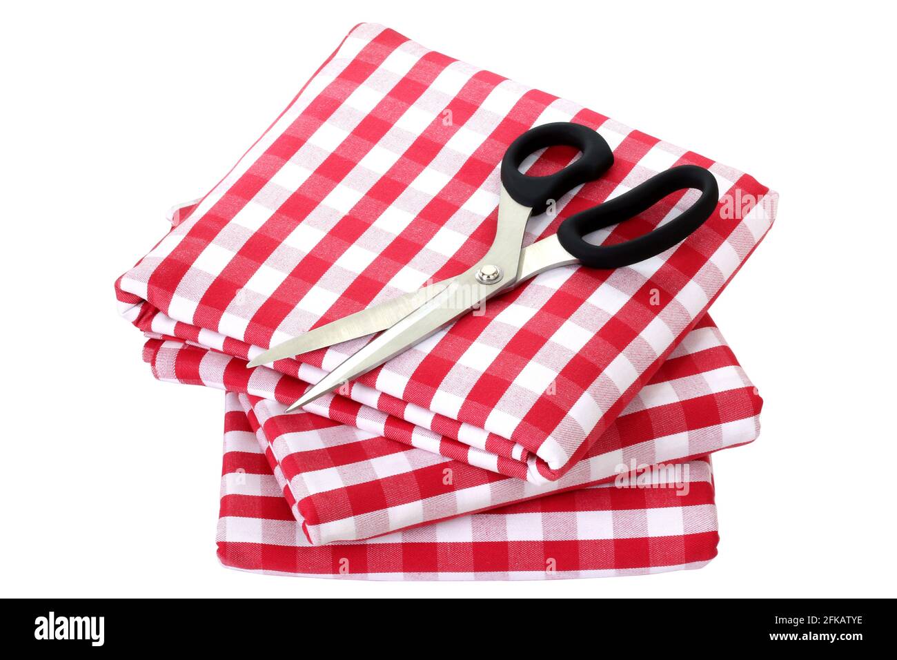 Folded fabric, gingham pattern, with a pair of scissors on it Stock Photo