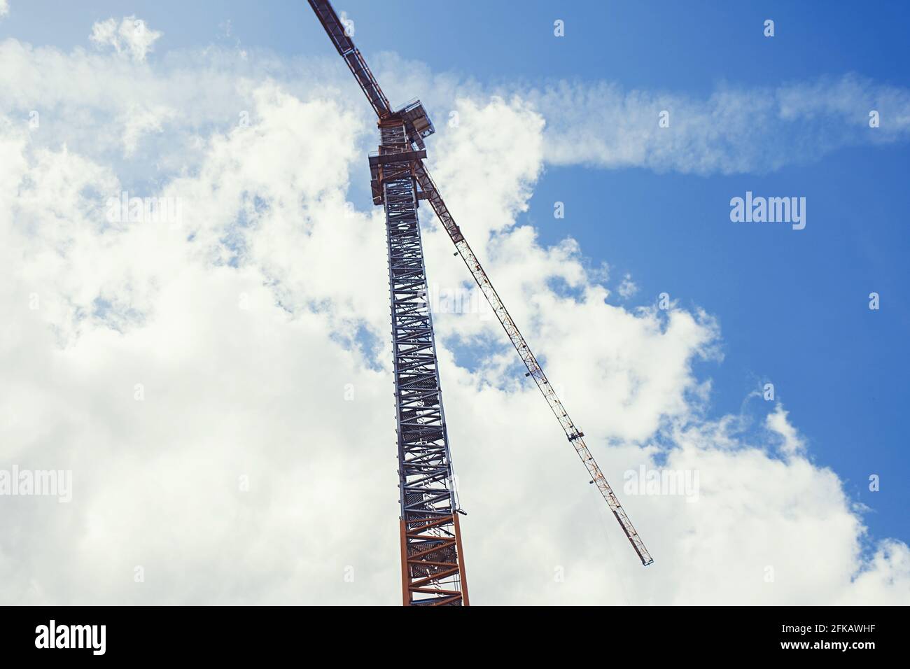 Construction crane against the blue sky background Stock Photo - Alamy