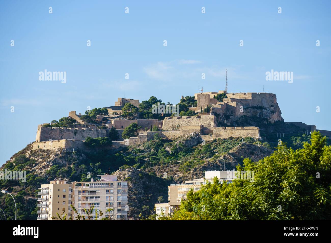 Santa Barbara Alicante castle at the top of a hill over the city. On a sunny day. Stone fortress. Comunidad Valenciana. Stock Photo