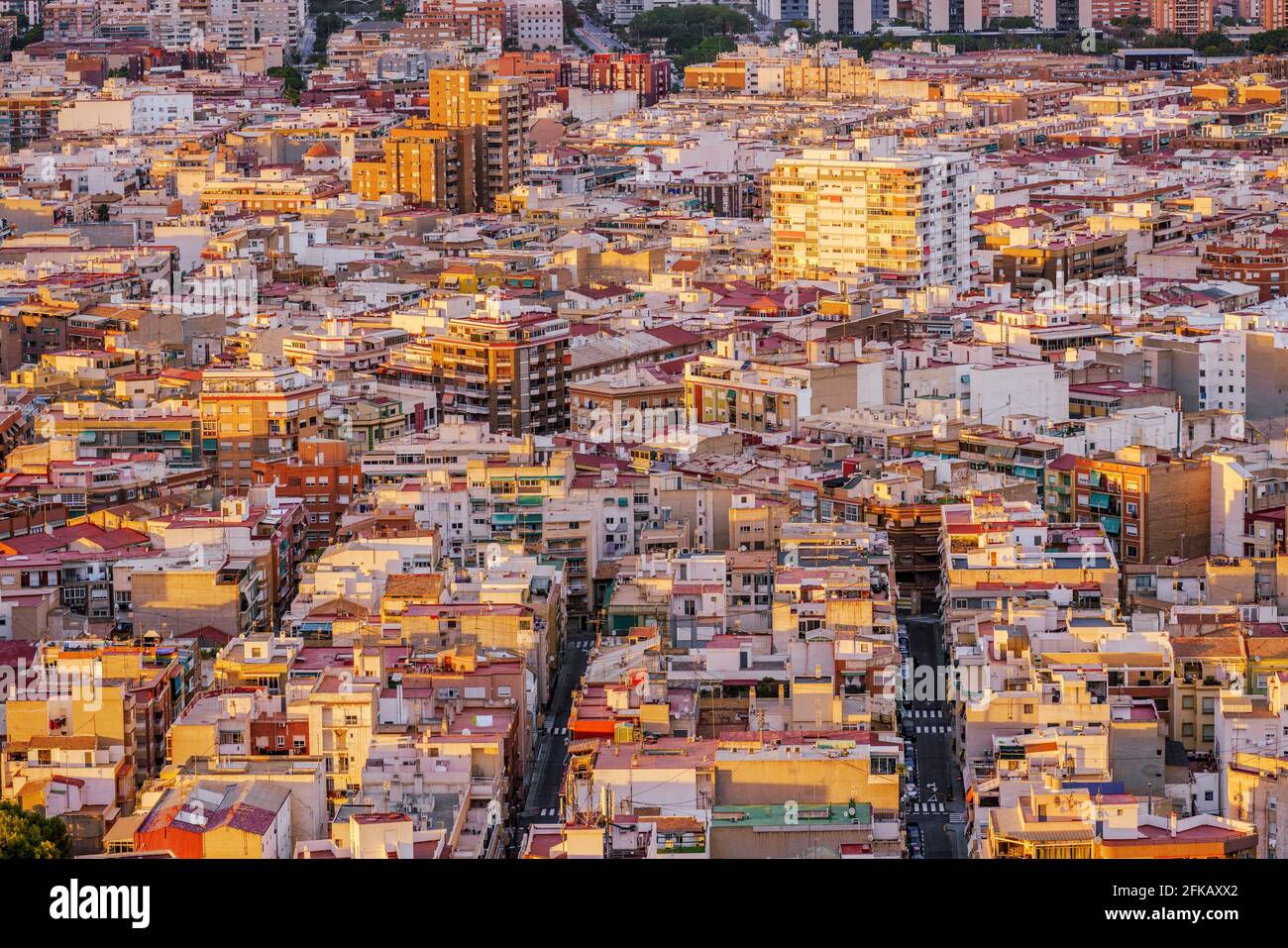 Highly dense populated city in Spain at sunset. Warm tones. High angle view. Alicante, Spain. Stock Photo