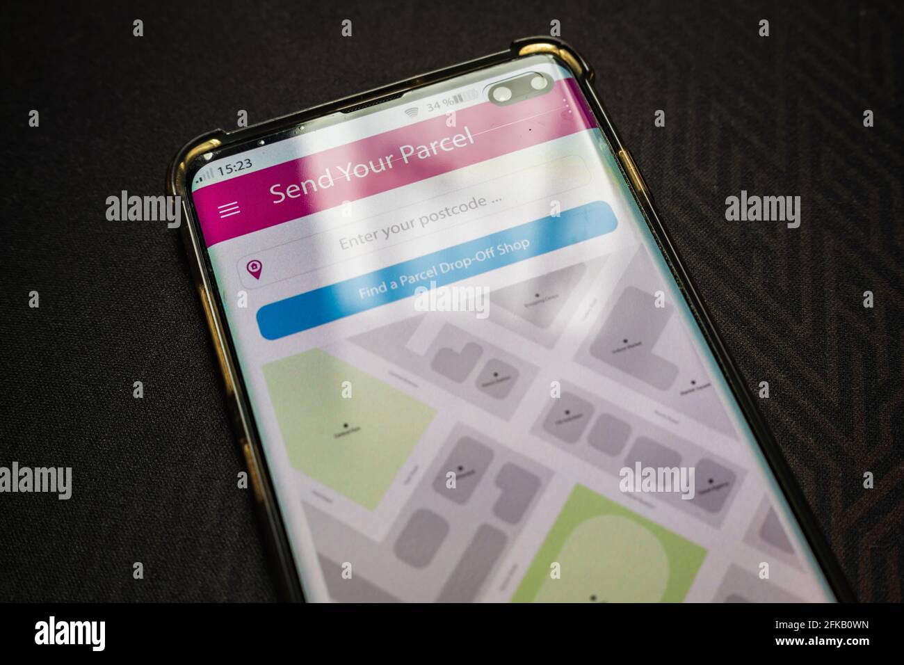 Male thumb finger over parcel delivery app on smartphone screen Stock ...