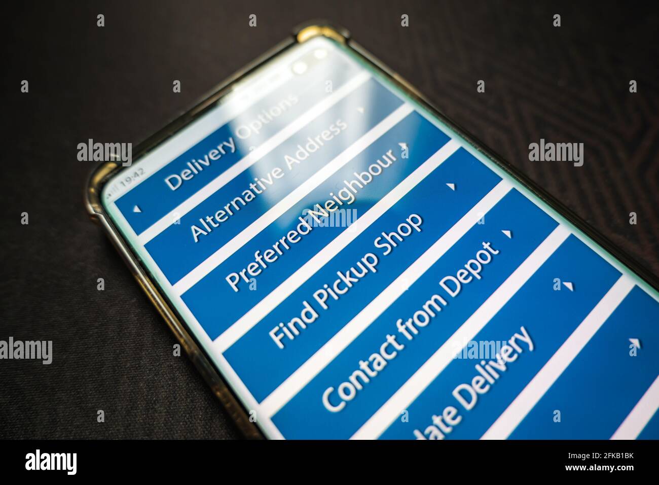 Male thumb finger over parcel delivery app on smartphone screen Stock ...