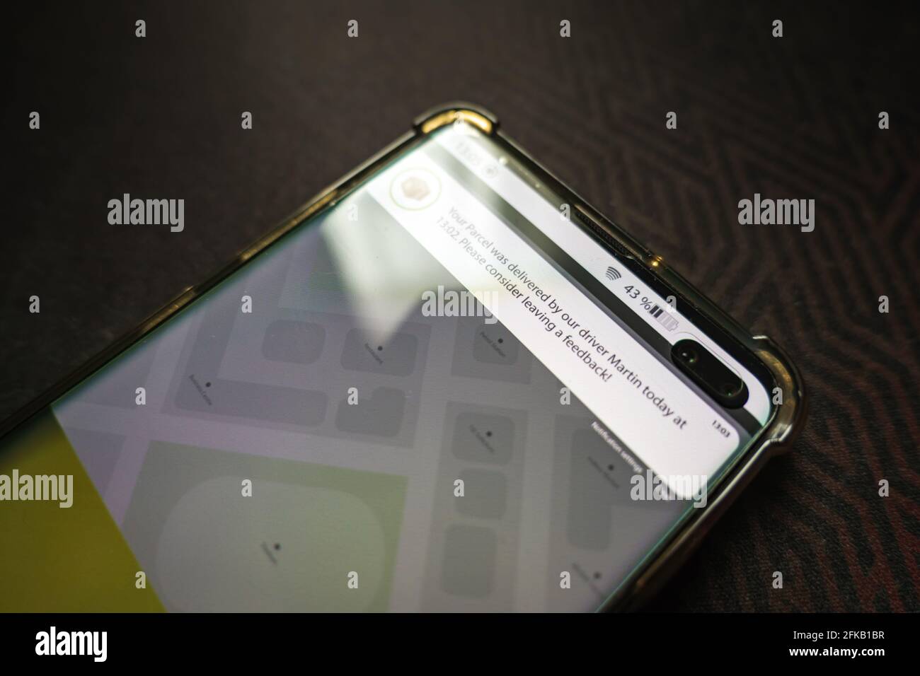 Male thumb finger over parcel delivery app on smartphone screen Stock ...