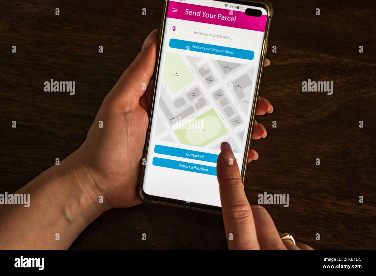 Male thumb finger over parcel delivery app on smartphone screen Stock ...