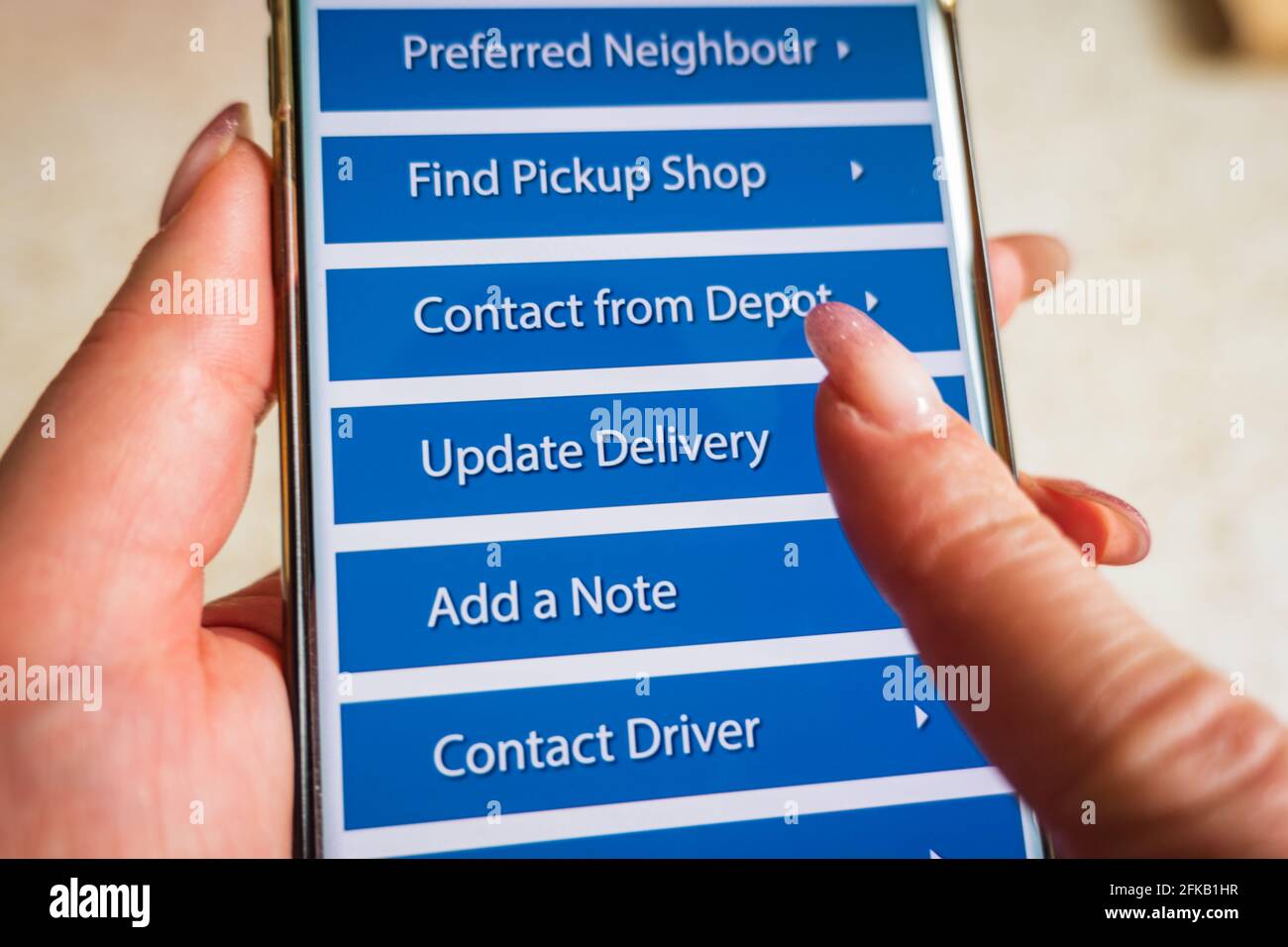 Male thumb finger over parcel delivery app on smartphone screen Stock ...