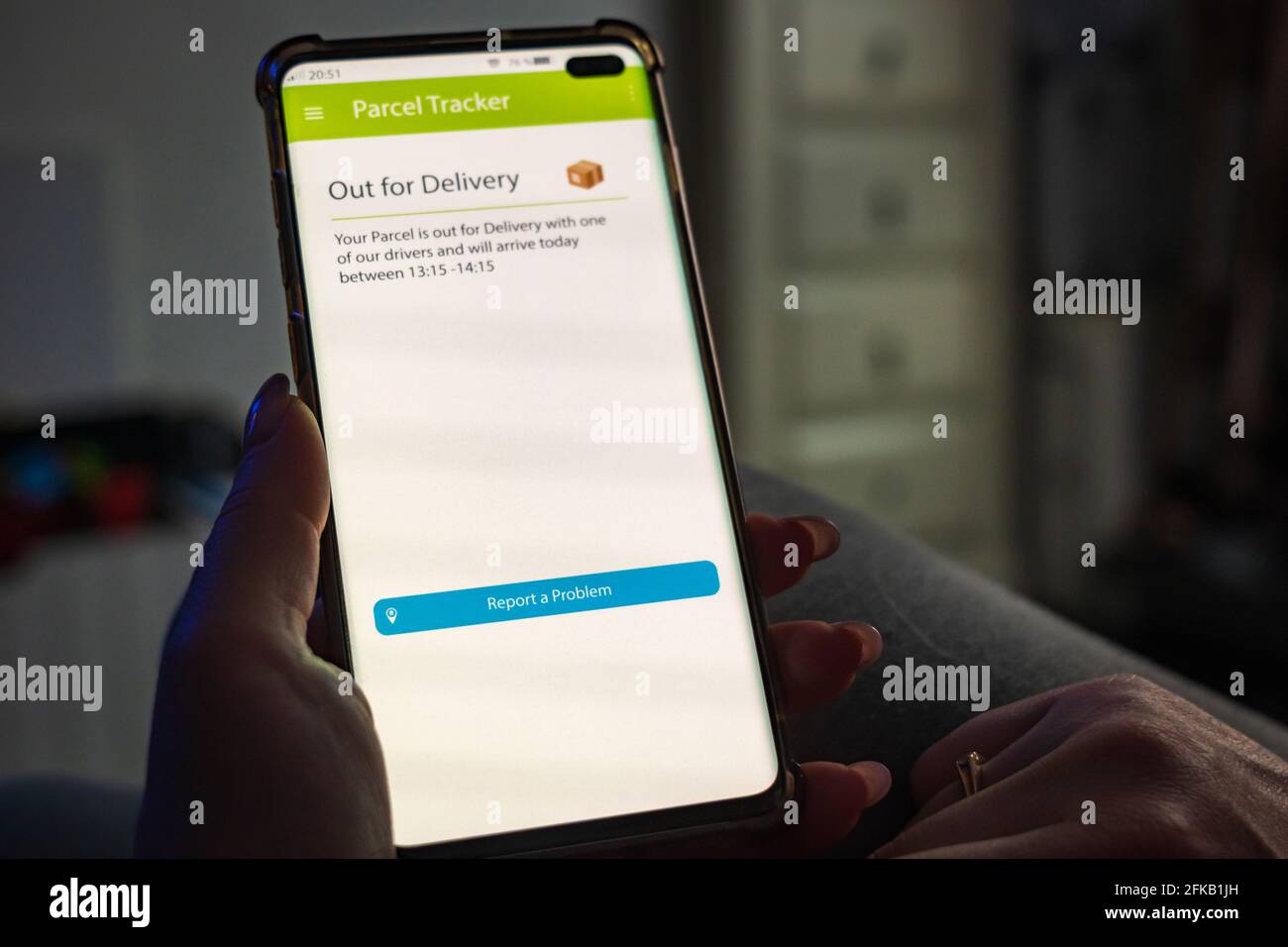 Male thumb finger over parcel delivery app on smartphone screen Stock ...