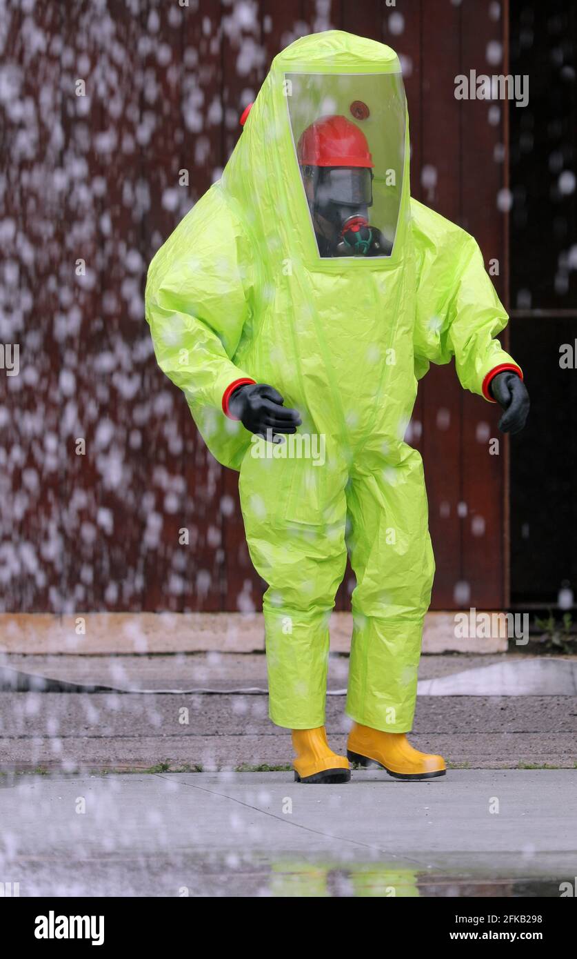 person in a yellow protective suit for protection against chemical and