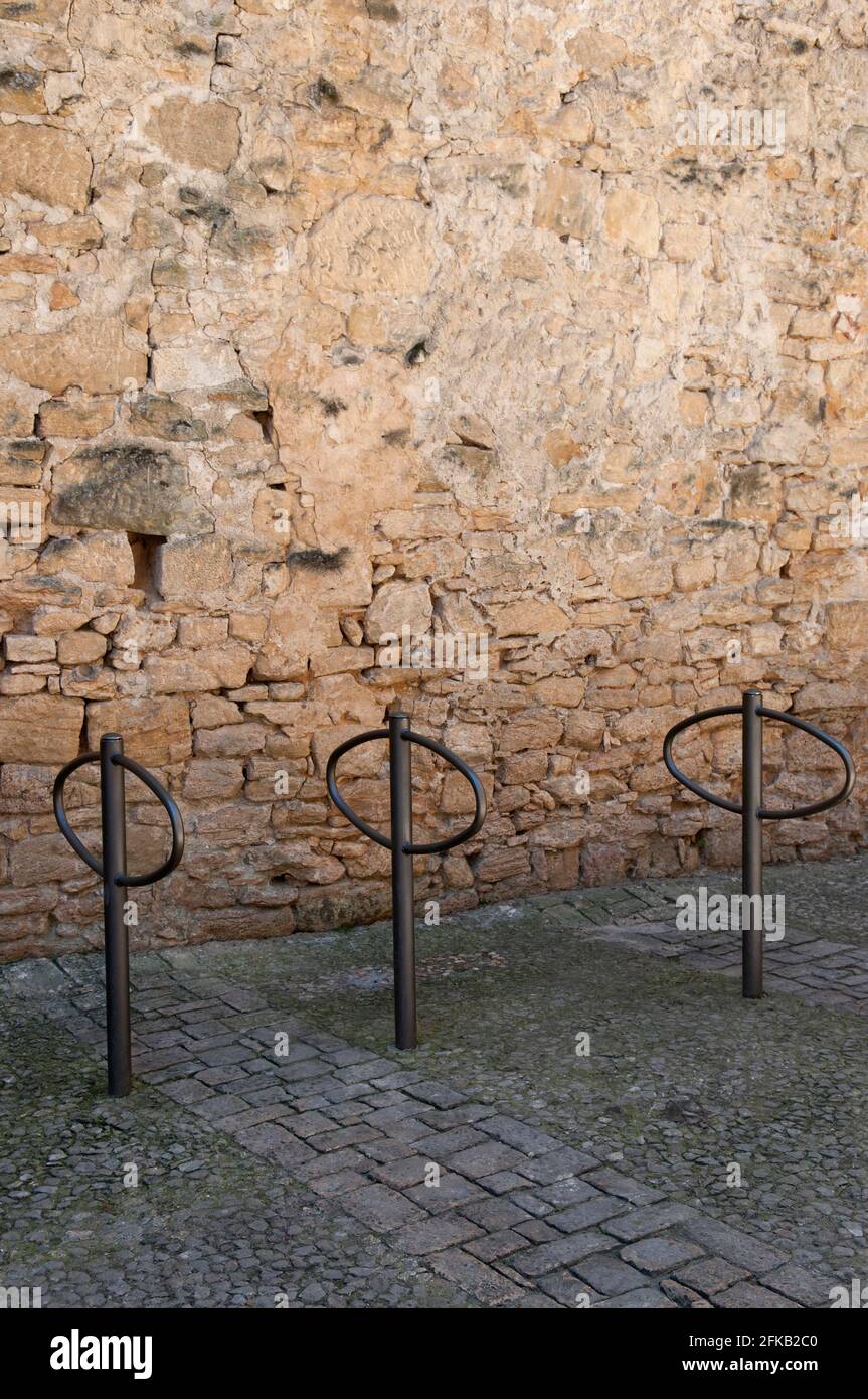Three Bike Racks In A Row In Front Of An Old Honey Coloured Stone Wall ...